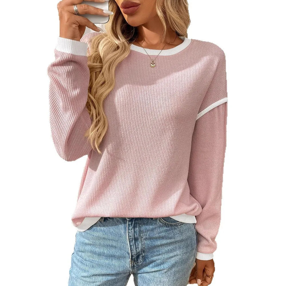 Women's loose-fitting long-sleeve polyester top in a round-neck pullover style on a hanger.