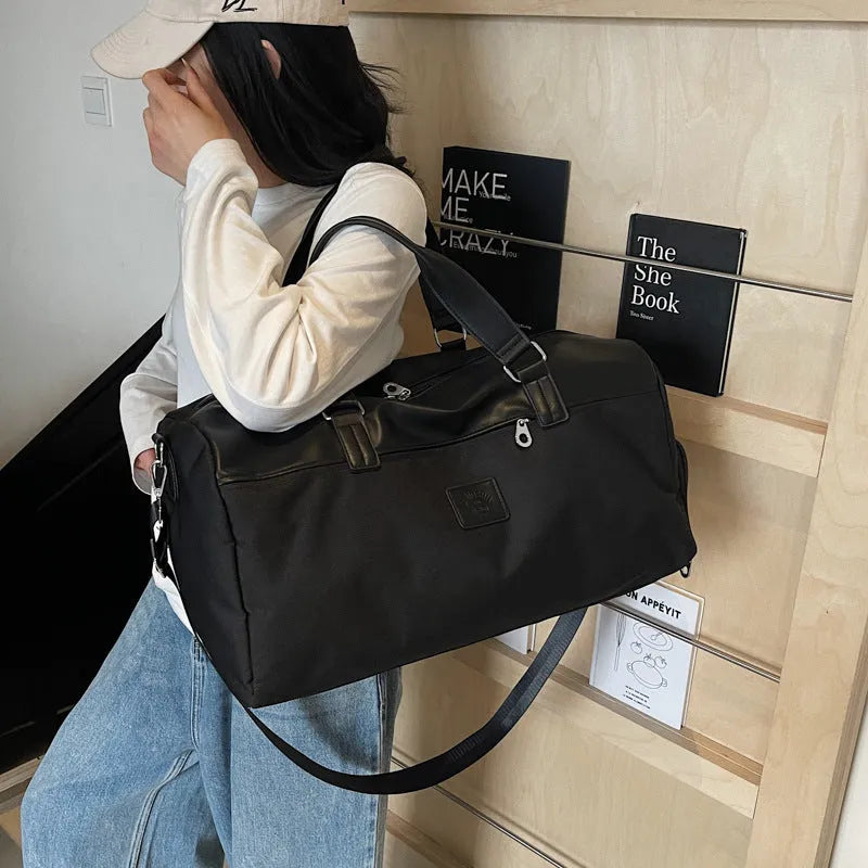 Large black messenger bag with 36-55L capacity for travel, made of Oxford cloth.