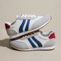 Blue and grey Cortez stripe leisure sports shoes with round toe and flat rubber sole.