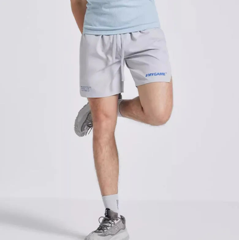 Men's navy blue training fitness shorts made from polyester spandex fabric, shown on a model.