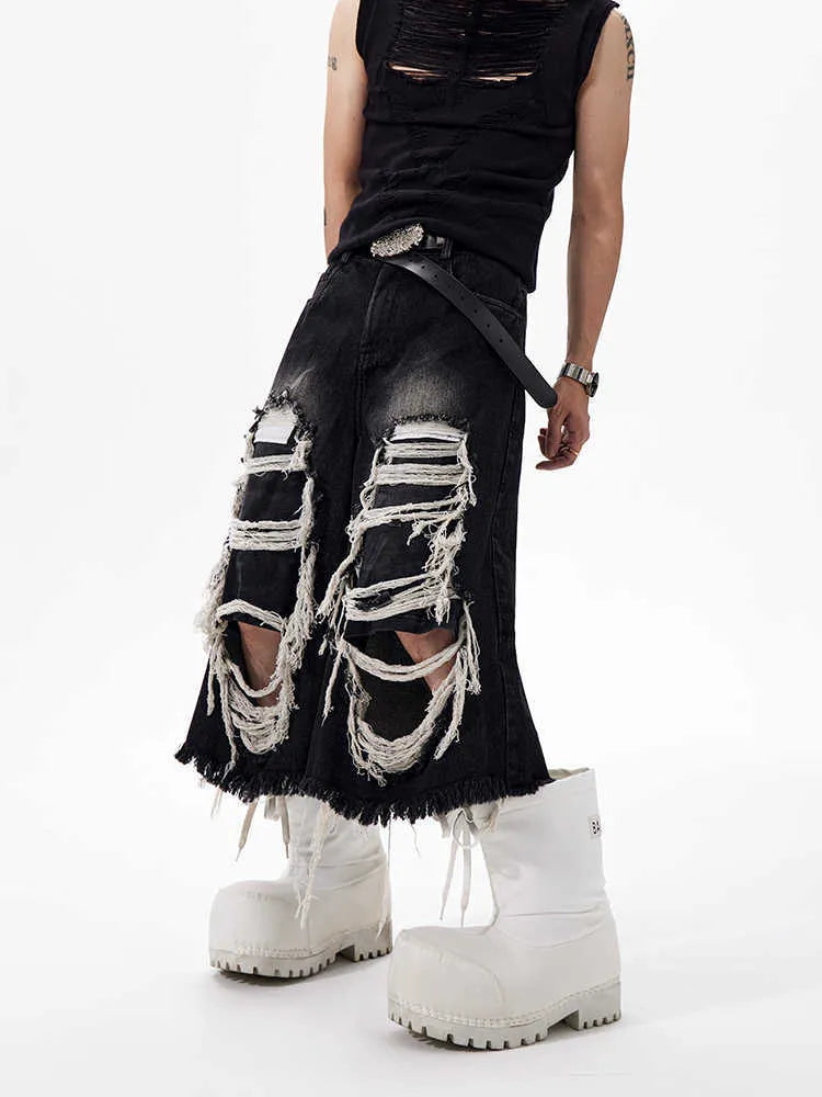 Black wide-leg cropped jeans with ripped patch details on a mid-high waist, loose fit.