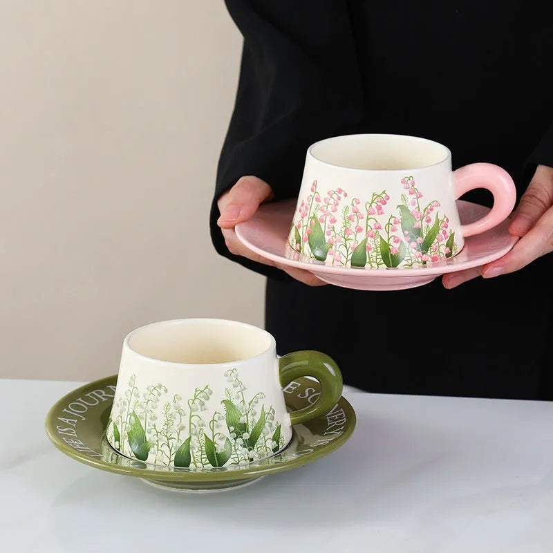 Ceramic coffee cup and saucer set for two in campanula floral design with stirring spoons