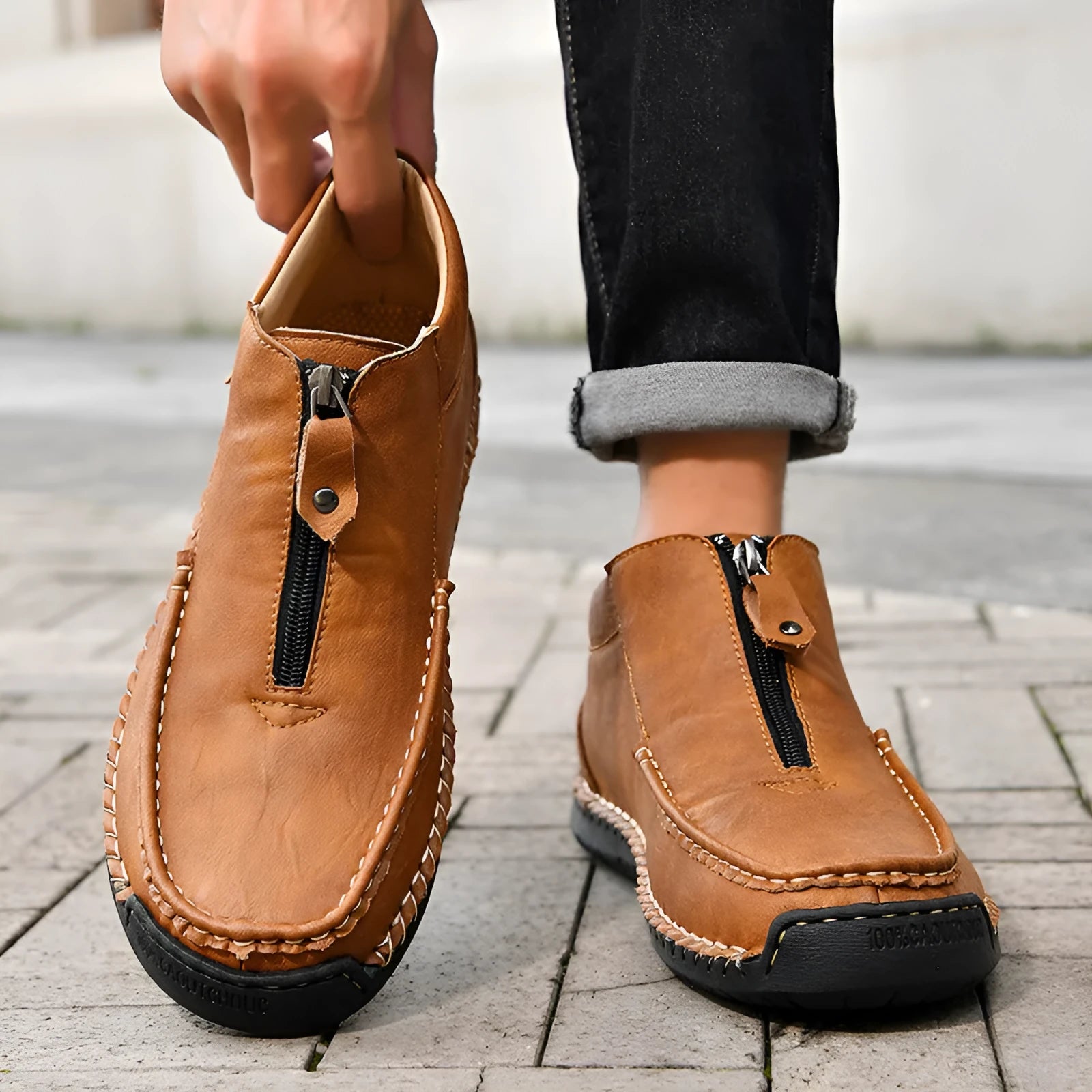 Men's brown slip-on leather loafers with round toe and rubber sole shown from side view
