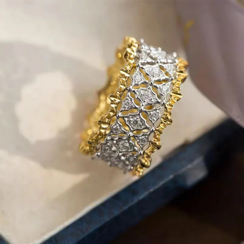 Geometric zircon ring with two-tone gold and silver electroplated finish on a copper band.