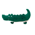 Green plush stuffed toy dog on a white background.