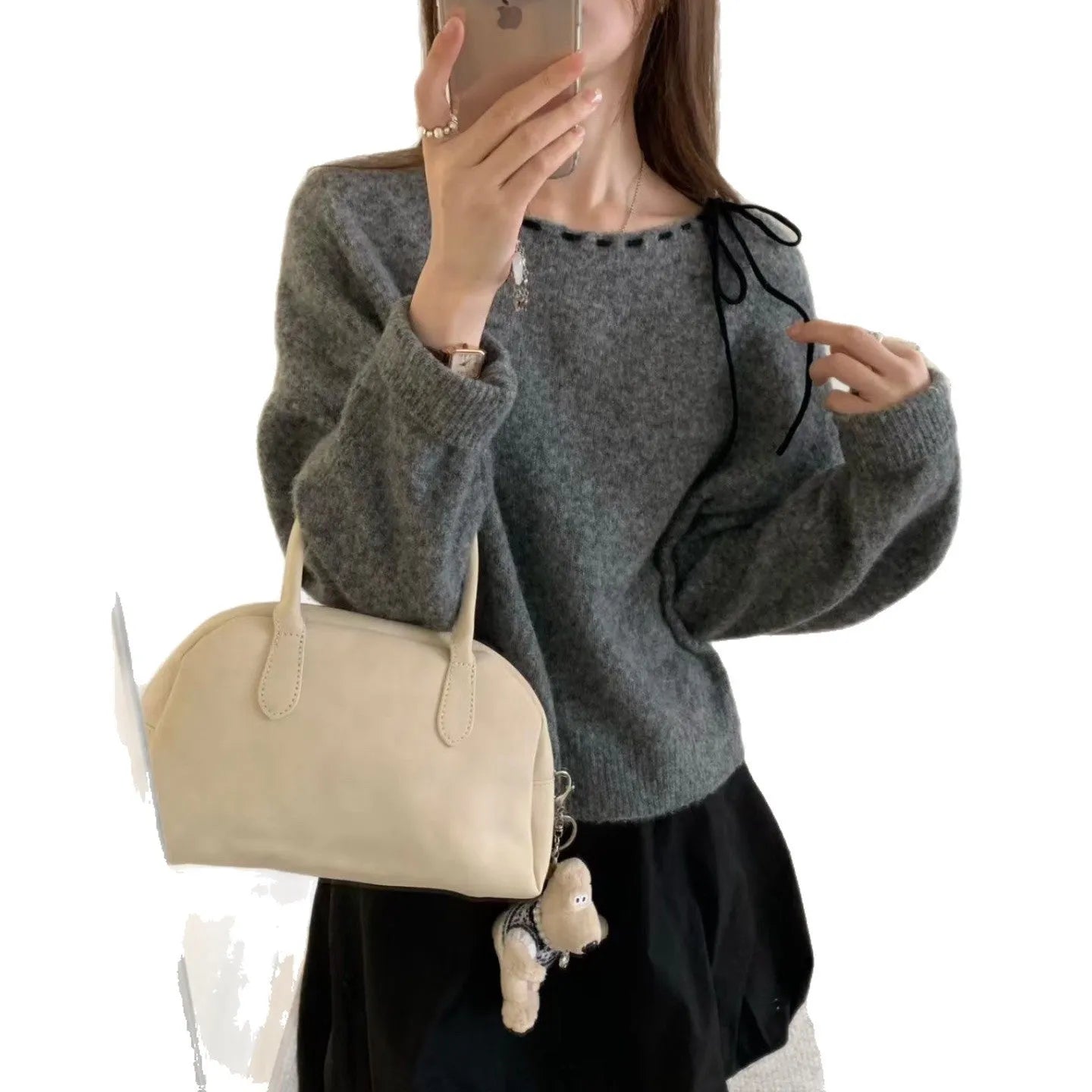 Grey loose-fitting women's pullover sweater made from regenerated cellulose knitwear on a hanger.