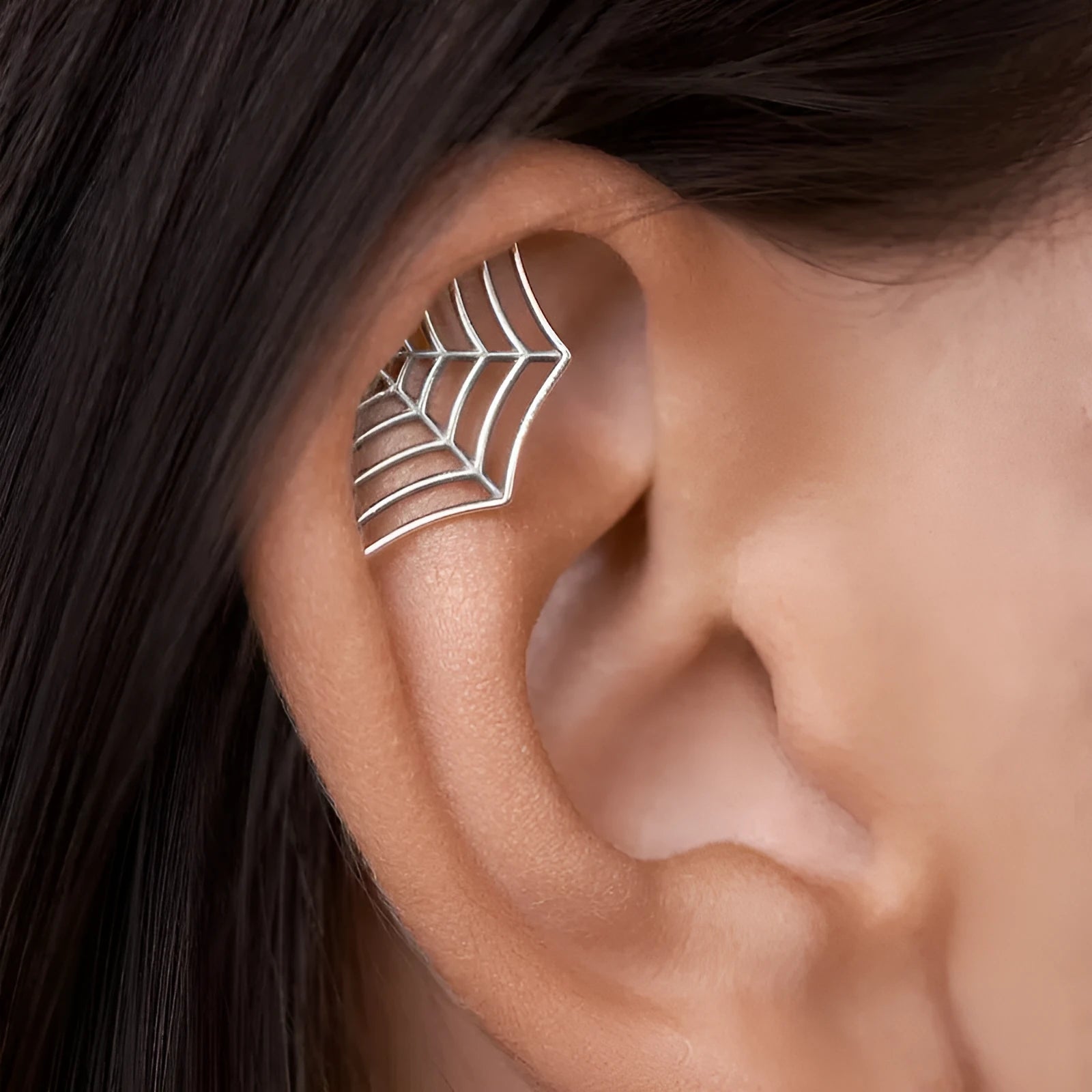 Spider web geometric mesh design stud earrings in gold and silver electroplated finishes.