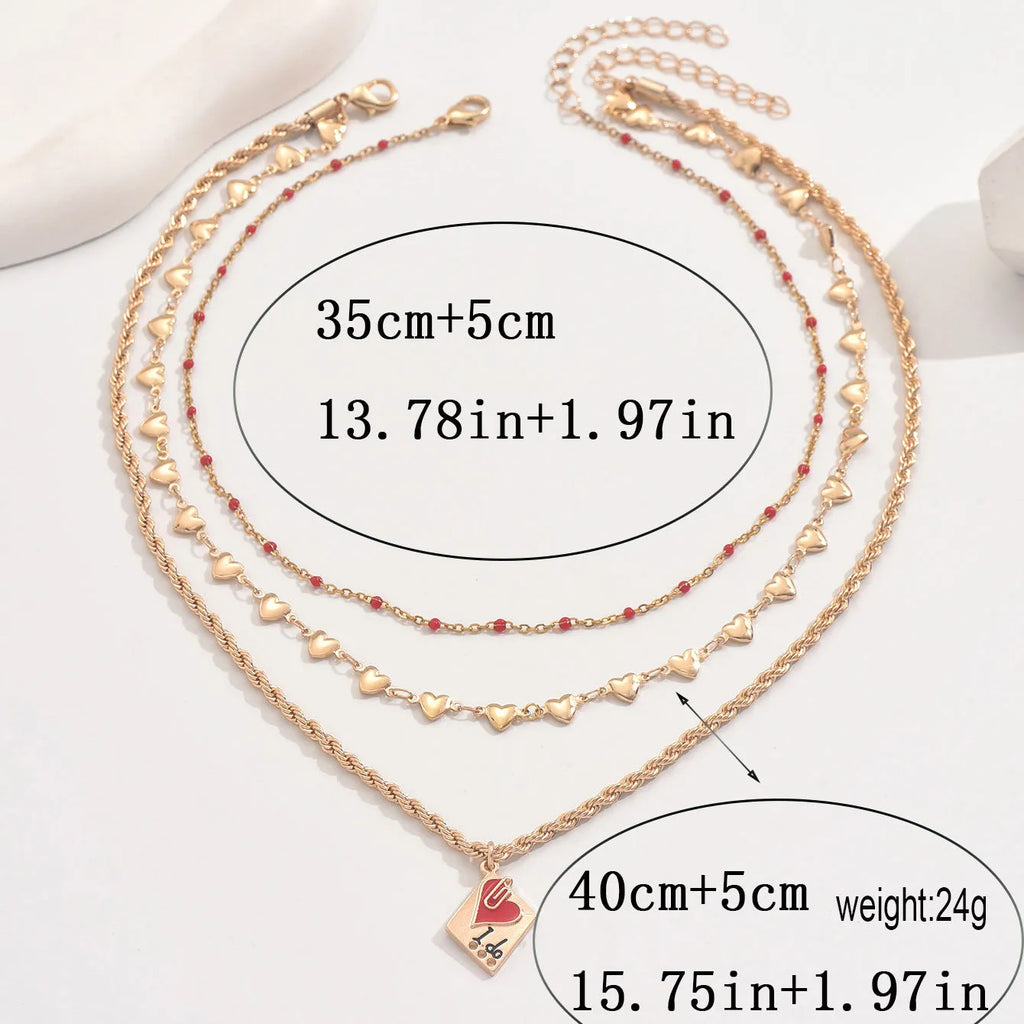 Gold tone three-layer love necklace with geometric pendant on a model.