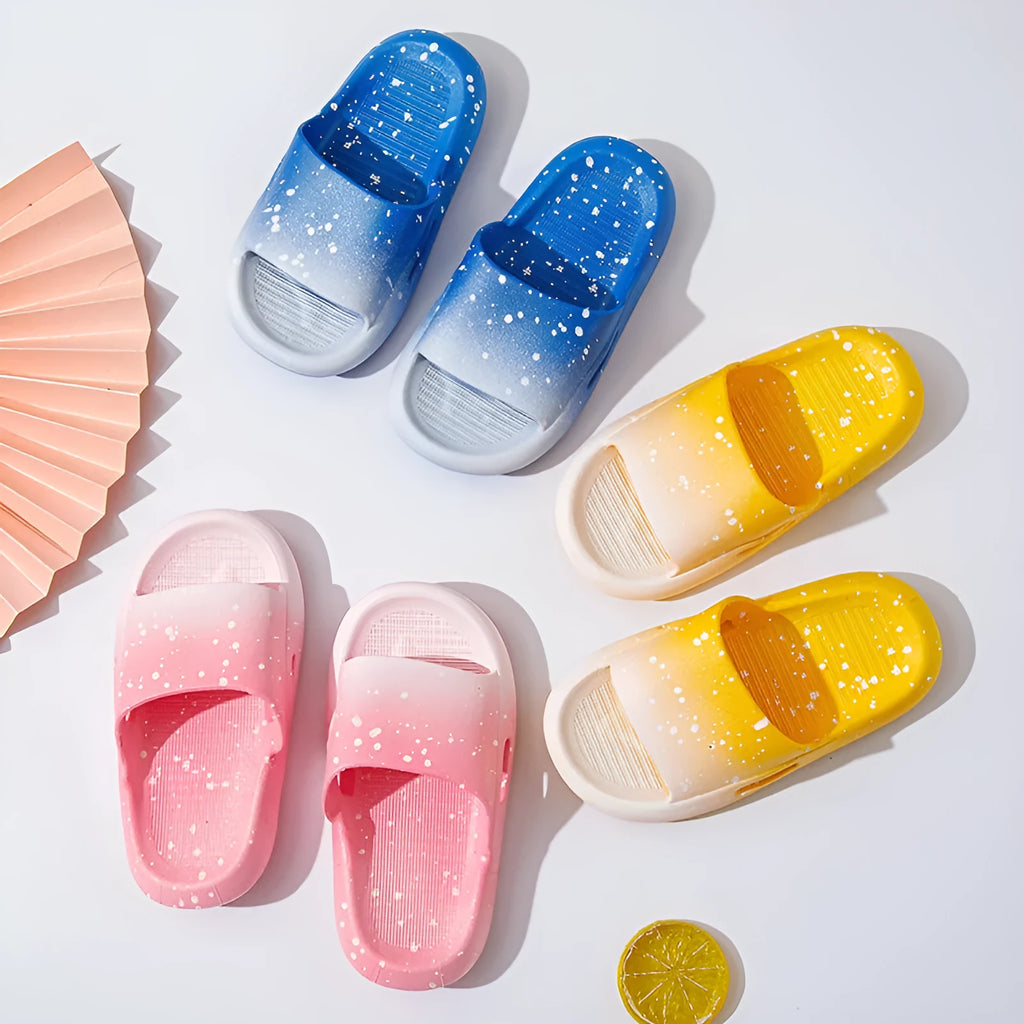 Gradient coloured PVC summer slippers for children on a plain background, showing the non-slip sole.