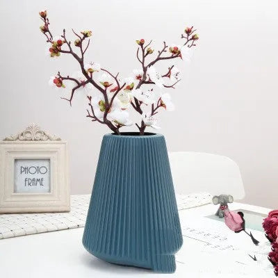 Blue, green, pink, and white melamine plastic decorative vase measuring 16cm by 20cm on a desktop.