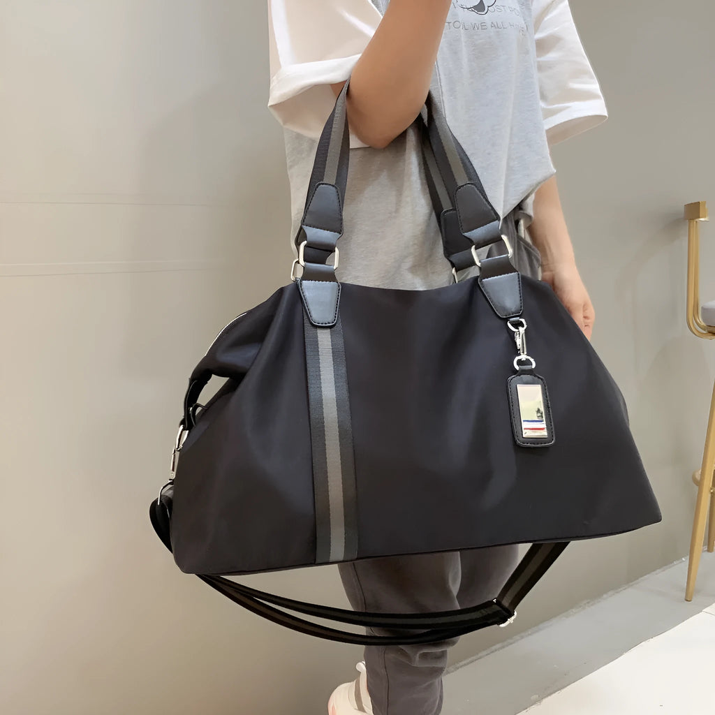 Black Gold Oxford cloth travel bag with zipper closure and three shoulder strap points on plain background