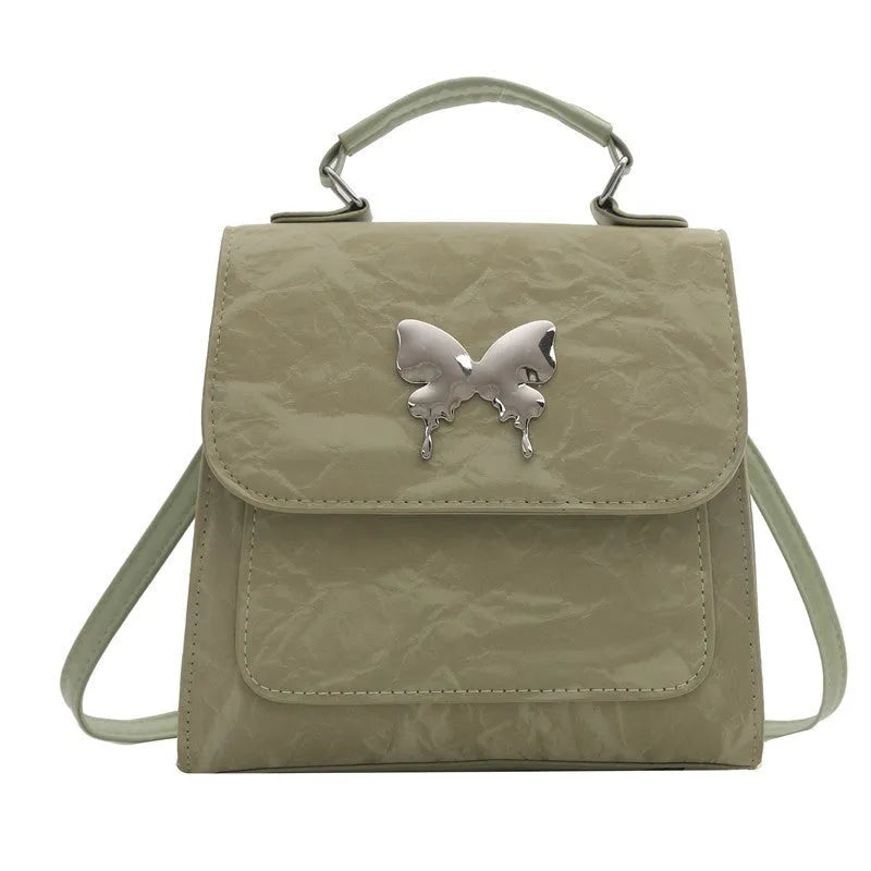 Women's preppy style PU backpack with hand-carry handle showing bow decoration and six colour options