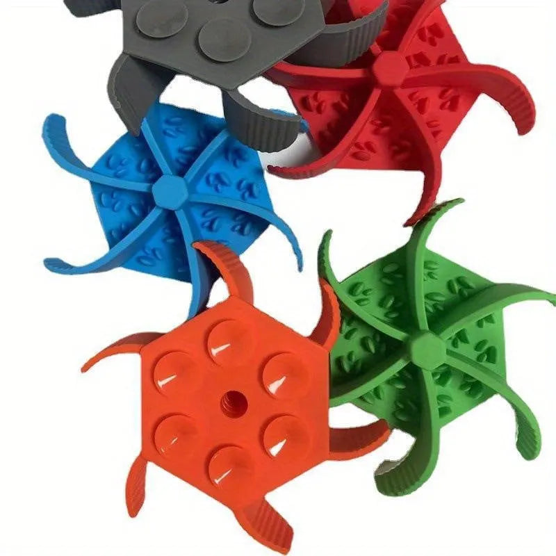 Silicone pet slow food device with sucker cup in green colour on a smooth floor