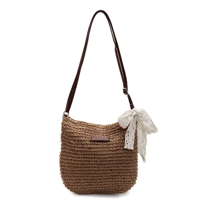 Women's straw woven messenger bag with hollowed design in khaki colour showing square shape
