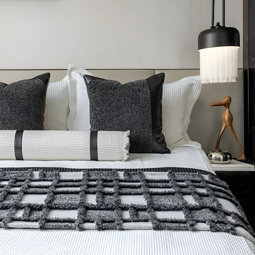 Modern minimalist grey and white plaid polyester bed runner set with pillowcase and round pillow on a bed.