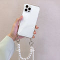 Soft mobile phone case with a white pearl charm chain attached, shown in a selected colour.