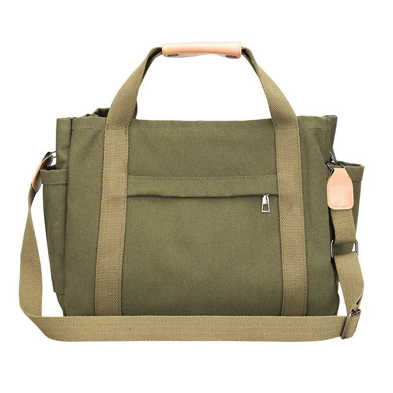 Horizontal square canvas tote bag in neutral colour with open zipper sides showing internal phone, document, computer and camera pockets