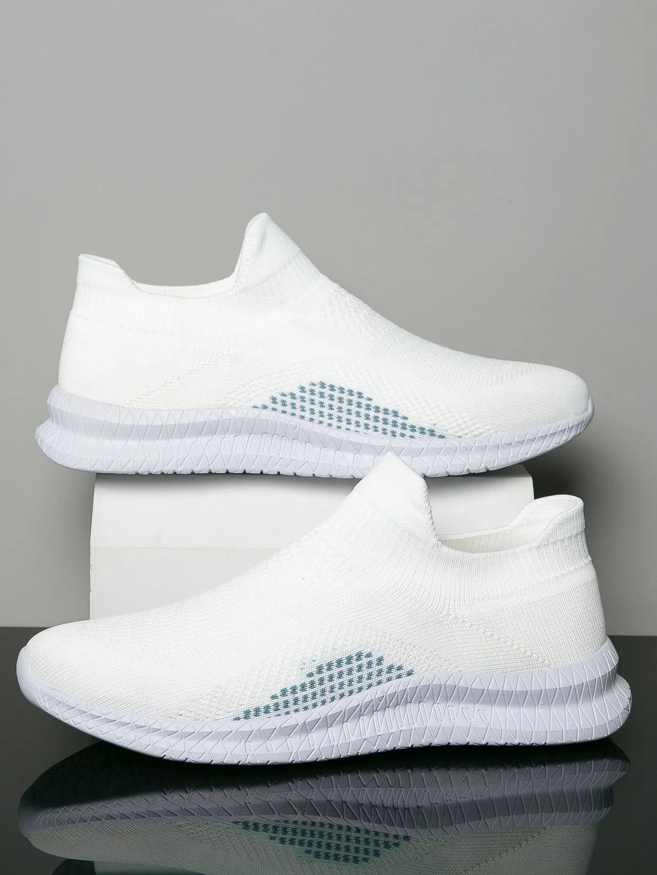 Men's white low-top fabric casual sneakers with round toe and flat sole on a neutral background.