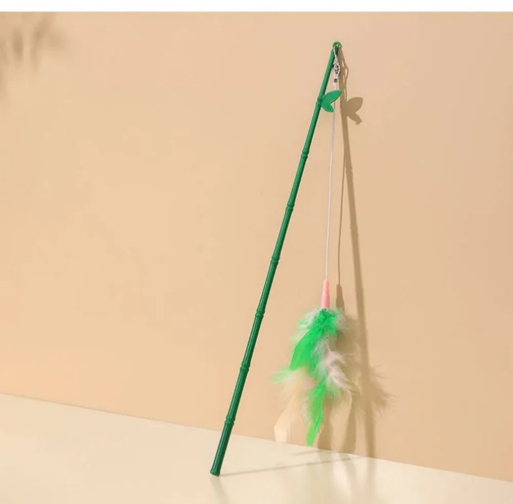 Green interactive cat feather wand toy with bells and feathers for indoor play and training