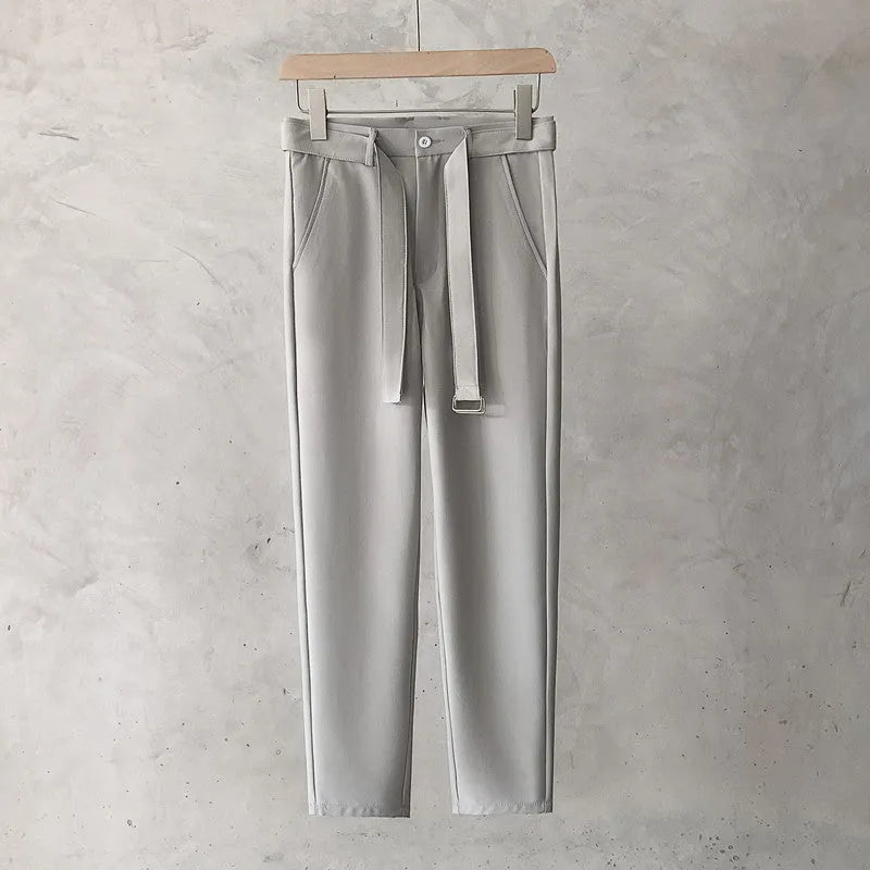 Boy wearing slim straight grey wool blend business casual trousers with a tapered fit
