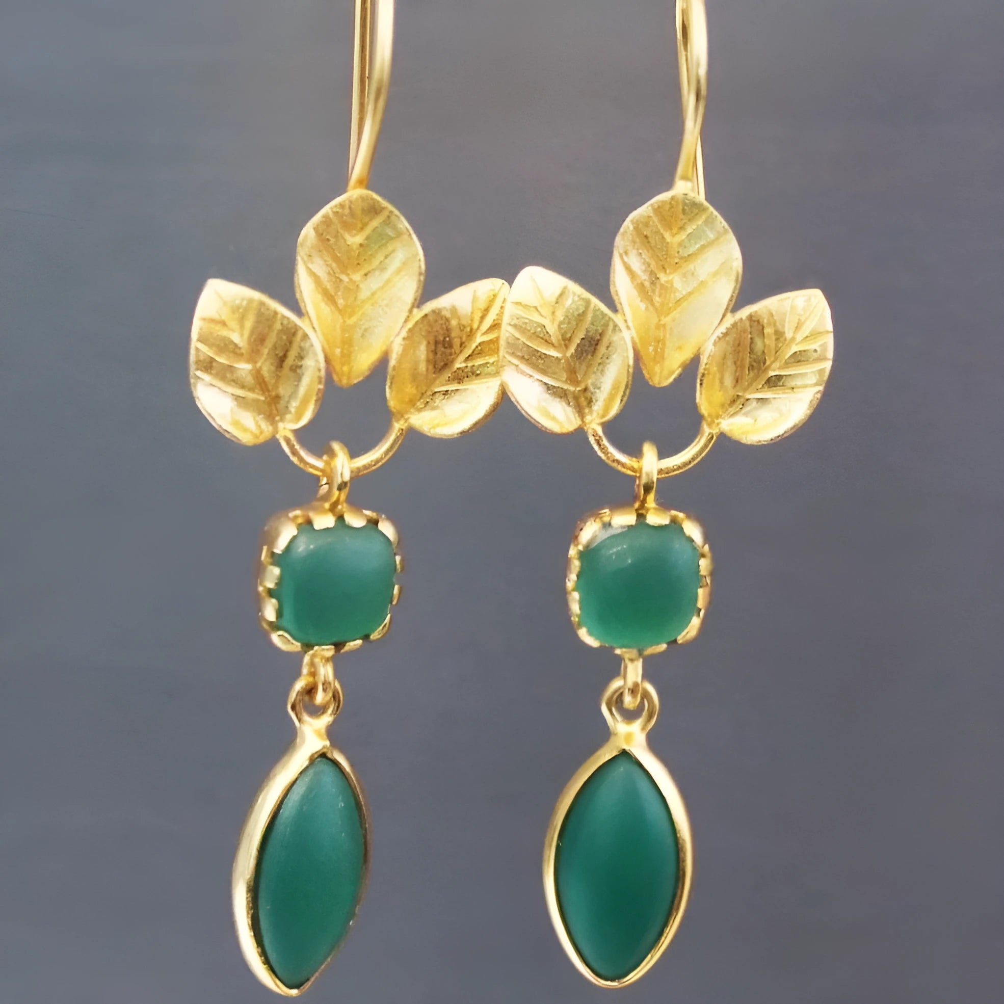 Gold tone retro drop earrings with a French leaves tassel design and a central water drop zircon stone.