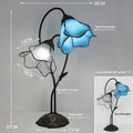 Retro American style desk lamp with lotus glass shade on wooden table.