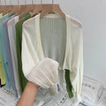 Women's white linen-look blouse with lantern sleeves and hollow-out detail, long sleeve