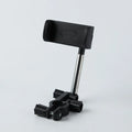 Black ABS car phone holder with 360-degree rotating mechanism mounted on car dashboard