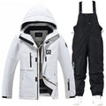 Blue and black two-piece ski suit for men and women on snowy mountain background