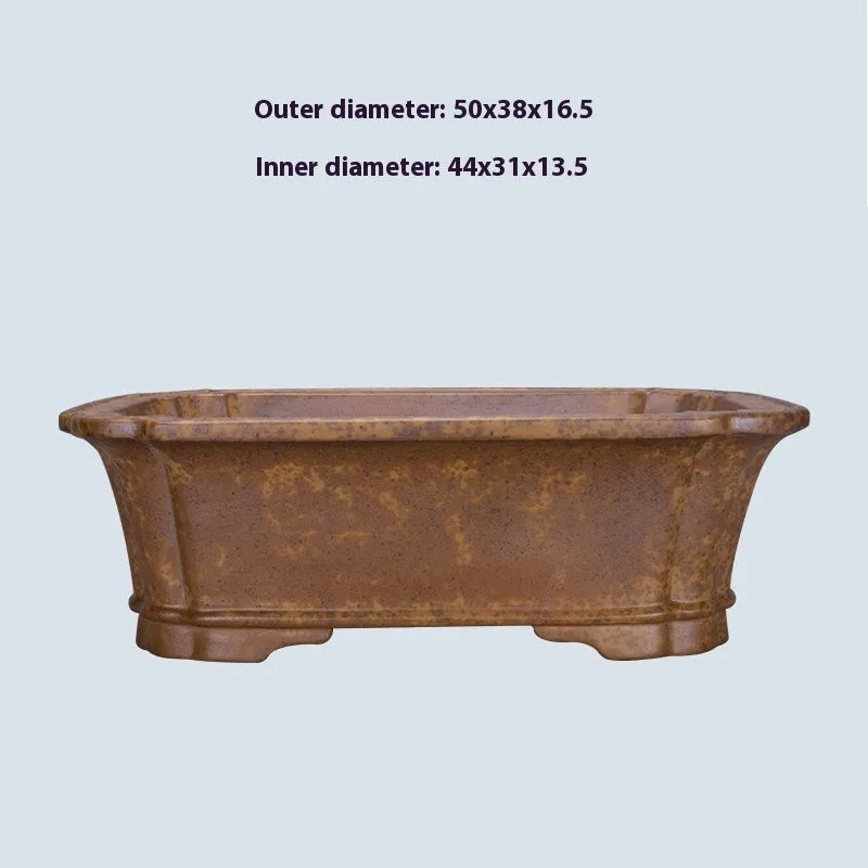 A large rectangular purple sand mud flowerpot with angled segment design on a floor.