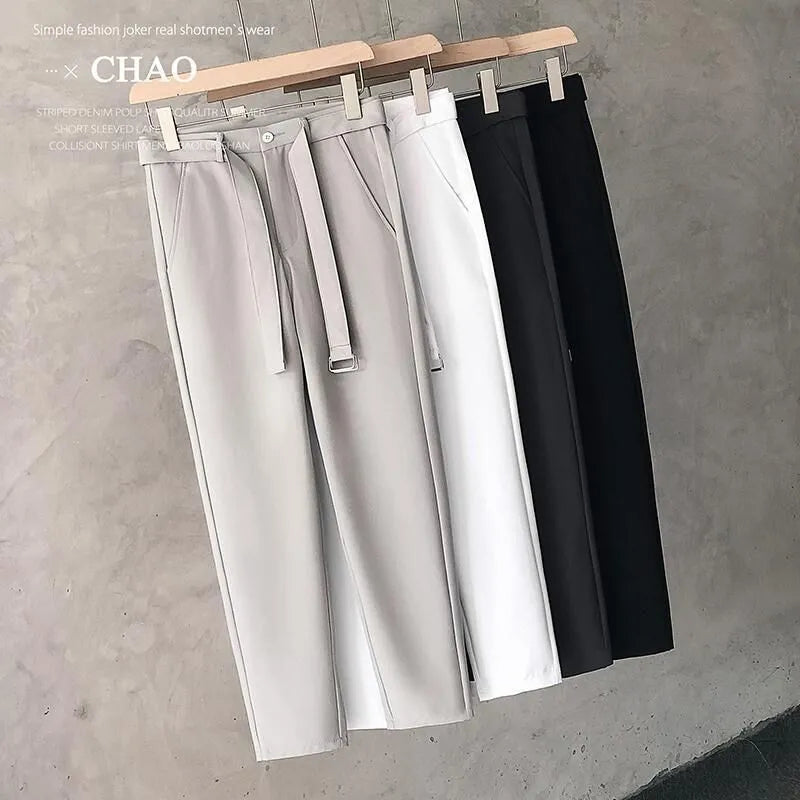 Boy wearing slim straight grey wool blend business casual trousers with a tapered fit