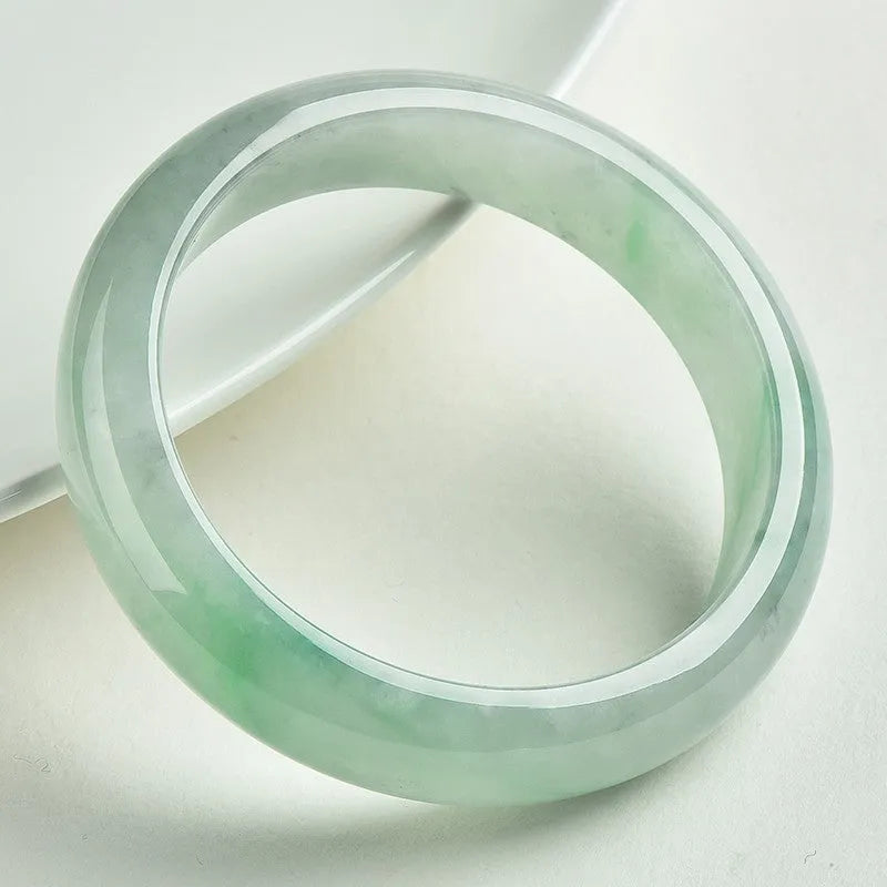 Light green jade bead bracelet showing natural stone texture with sizing options from 53mm to 64mm