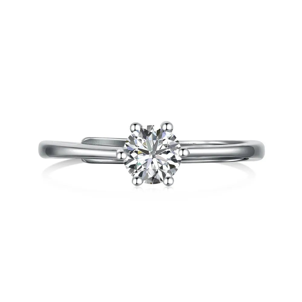 Sterling silver ring with six-claw zircon setting and open mouth adjustable band on white background