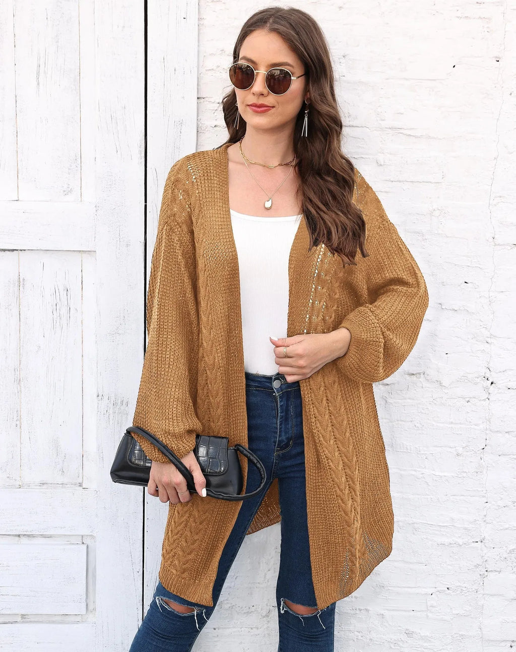 Loose-fitting women's acrylic sweater coat in a solid colour, shown on a model.