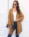 Loose-fitting women's acrylic sweater coat in a solid colour, shown on a model.
