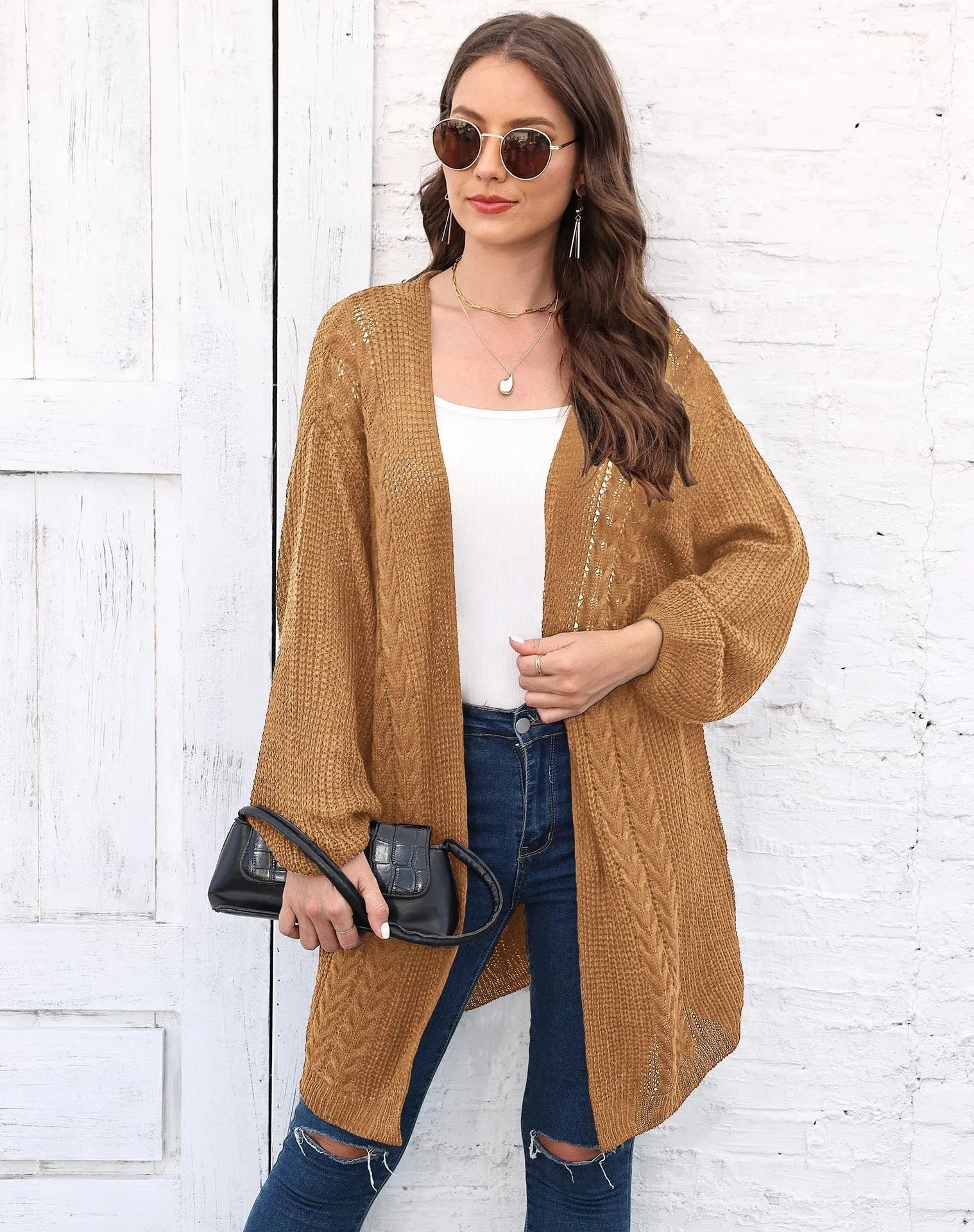 Loose-fitting women's acrylic sweater coat in a solid colour, shown on a model.