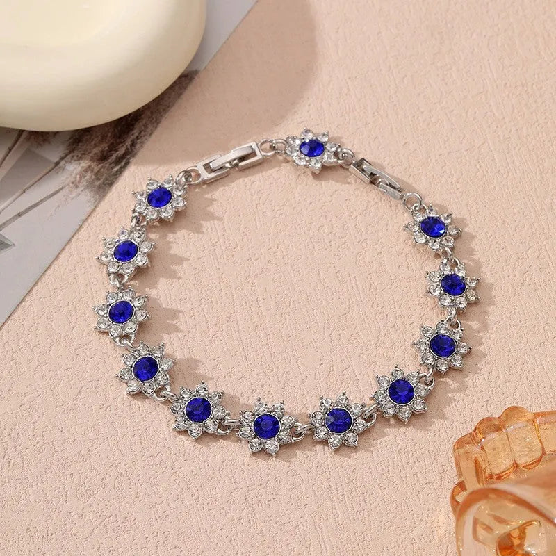 Electroplated zinc alloy floral bracelet showing colour variations including gold and silver tone options