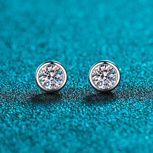 Gold-plated geometrical stud earrings with moissanite or zircon stone on a white background.