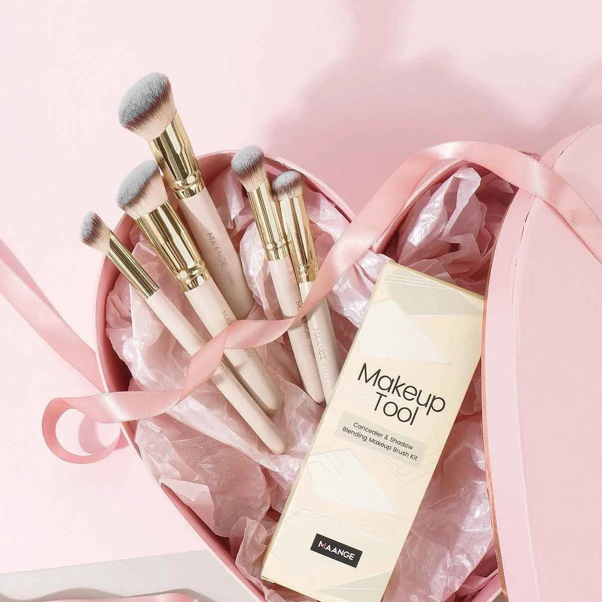 Apricot coloured MAANGE angled blush brush and 4-piece makeup brush set on white background