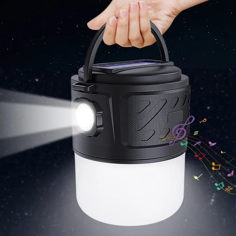 Portable solar camping lantern speaker with Bluetooth, LED light, USB rechargeable, black colour, on outdoor lawn