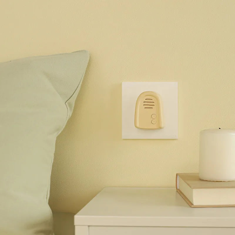 Wireless plug-in doorbell beeper for household use in white or milky yellow.