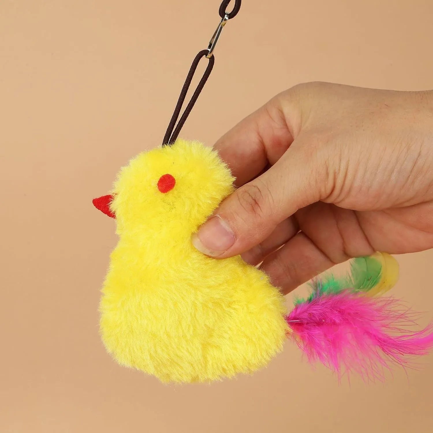 Interactive cat toy hanging on door frame with retractable rope, swinging attachments and treat reward bulb