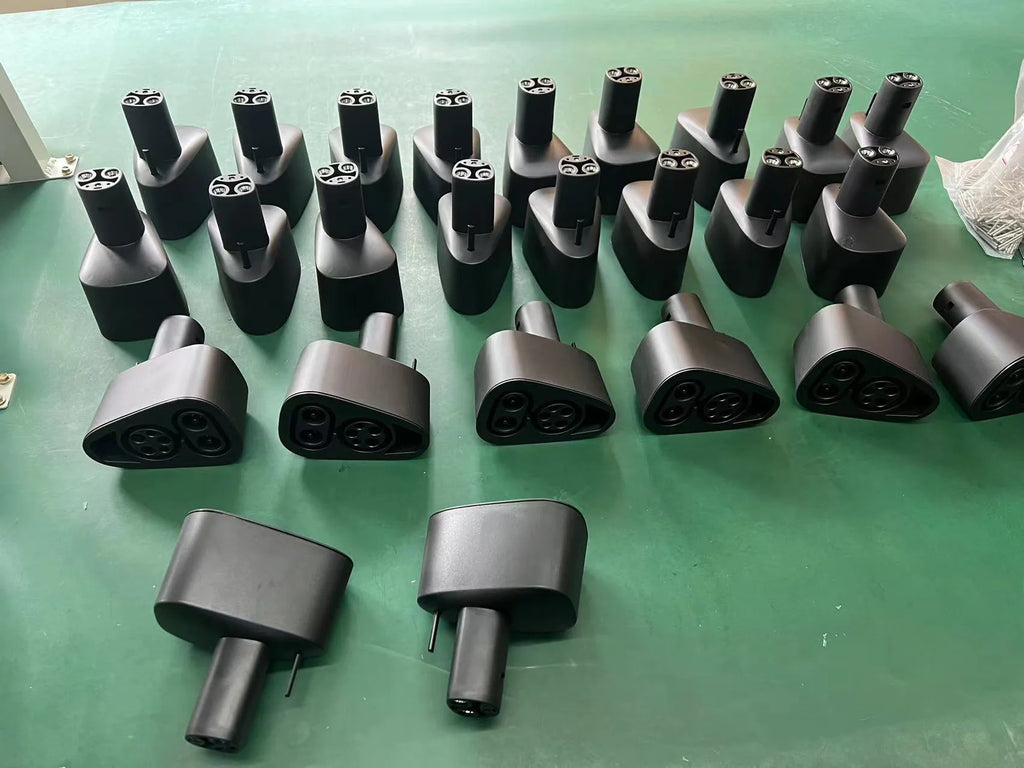 Black Tesla charging plug conversion adapter with dimensions 195mm by 96mm by 67mm