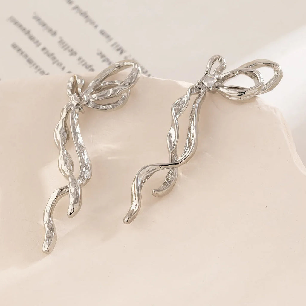 Bowknot earrings for women, alloy with electroplated White K finish, stud style, approximately 2.5cm width
