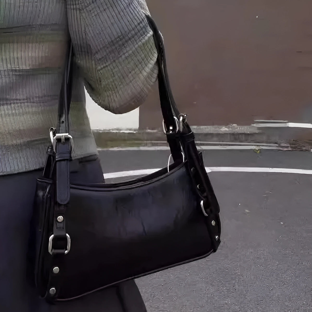 Black PU shoulder bag with horizontal square shape, outer three-dimensional pocket, and internal zipper change bag.