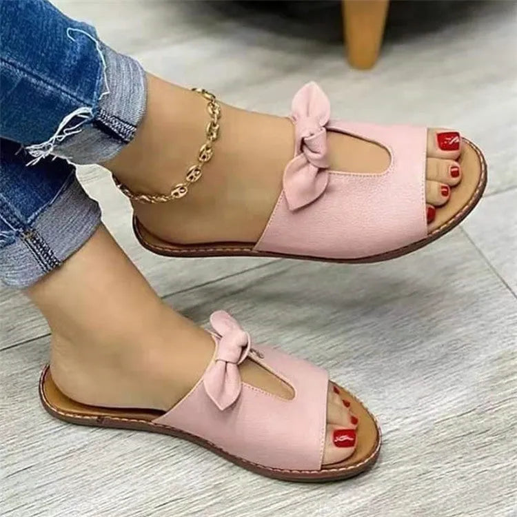 Ladies' casual sandals in black with a fishmouth style and a decorative bow on the upper.