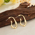 Gold irregular shaped minimalist dangle drop earrings for women with abstract geometric outline