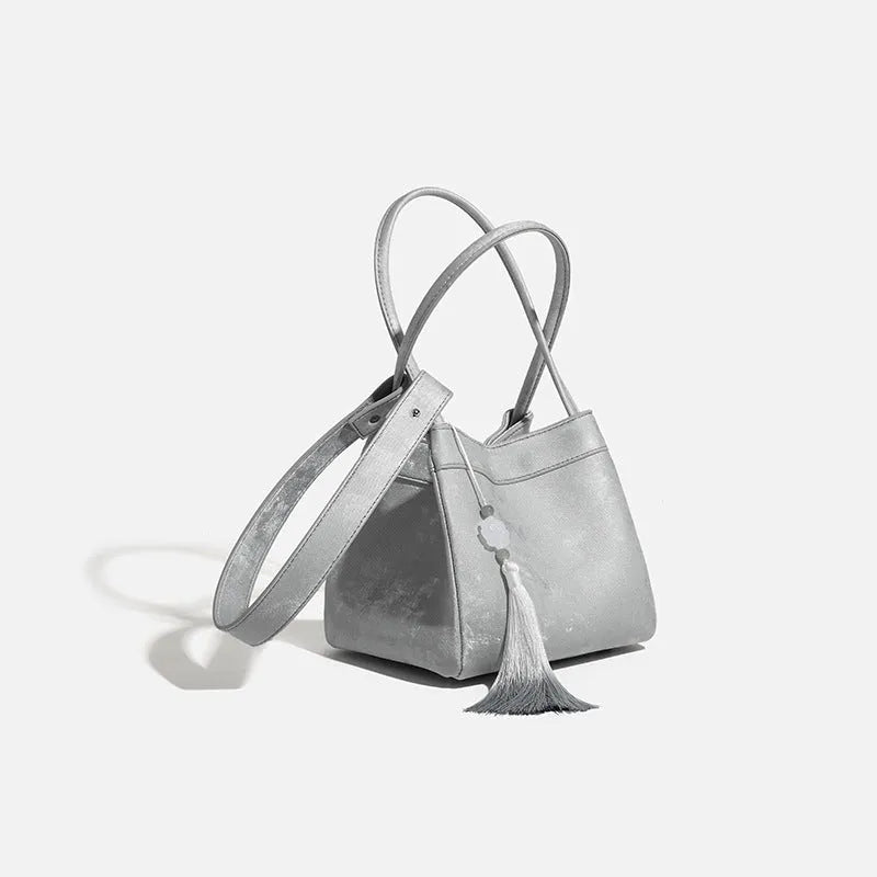 PU leather shoulder crossbody bag with single strap, tassel, open pocket, and sewing thread detail