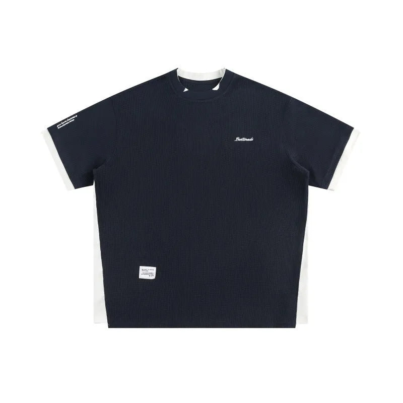 Loose fit grey waffle knit t-shirt with retro alphabet embroidery on the front.