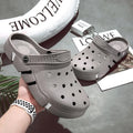 Men's non-slip EVA closed toe sandals in black with hollow-out design and height increasing sole.